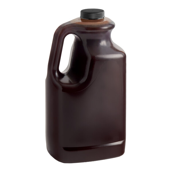A large plastic jug containing 64 fluid ounces of Dona chocolate sauce with a black screw cap.