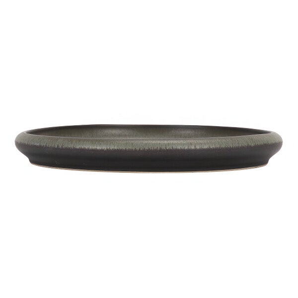 A round green and brown stoneware plate with a slightly raised rim.