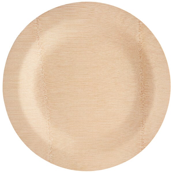 A round, light-colored compostable bamboo plate.