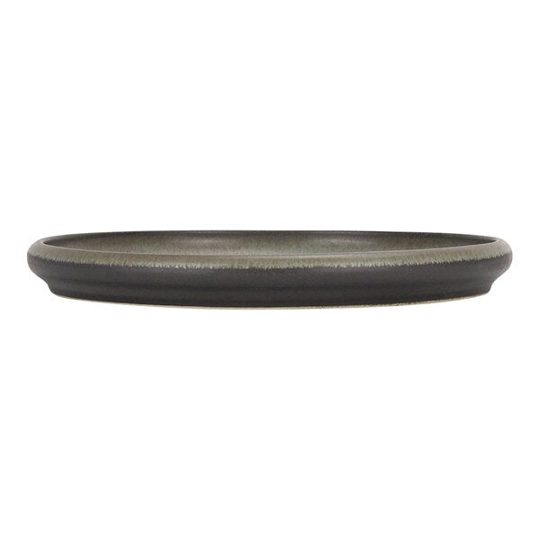 A round green and brown stoneware plate with a slightly raised rim.