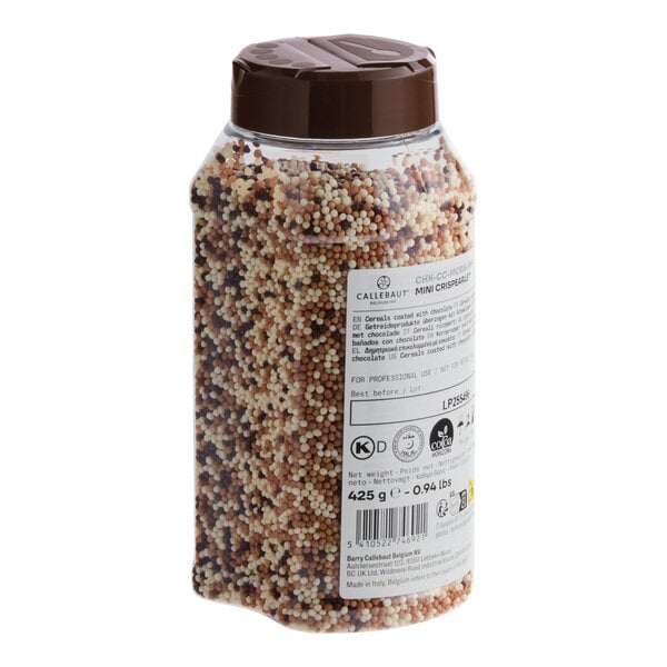 A plastic container filled with mini mixed chocolate crispearls.