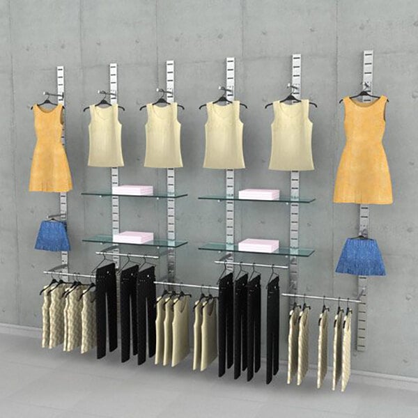 A vertical wall-mounted retail clothing display system with five sections, featuring hanging rails, faceouts, and glass shelves for showcasing garments and accessories.