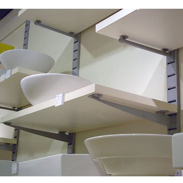 A heavy-duty vertical wall-mount retail display with multiple shelves holding white ceramic basins.