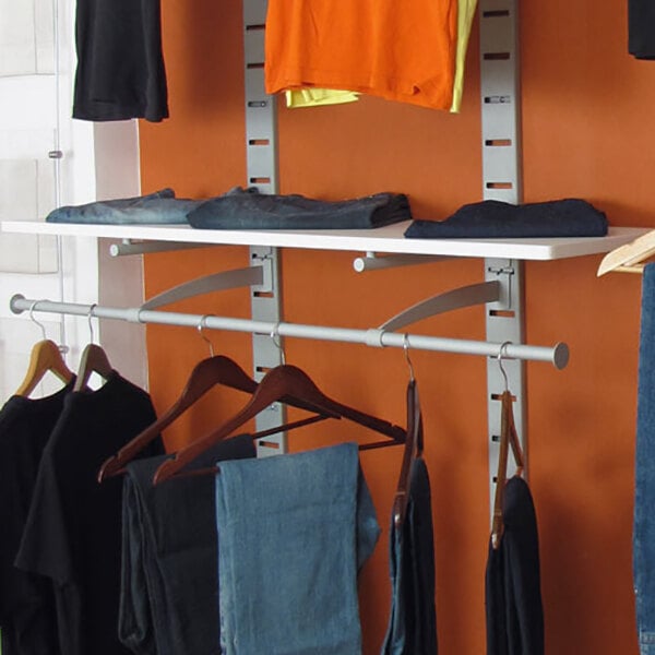 A vertical wall-mount retail clothing display with two hanging rails and shelving for folded and hanging garments.