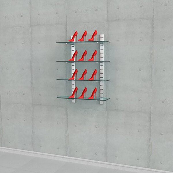A wall-mounted retail display with four glass shelves holding pairs of red high-heeled shoes.