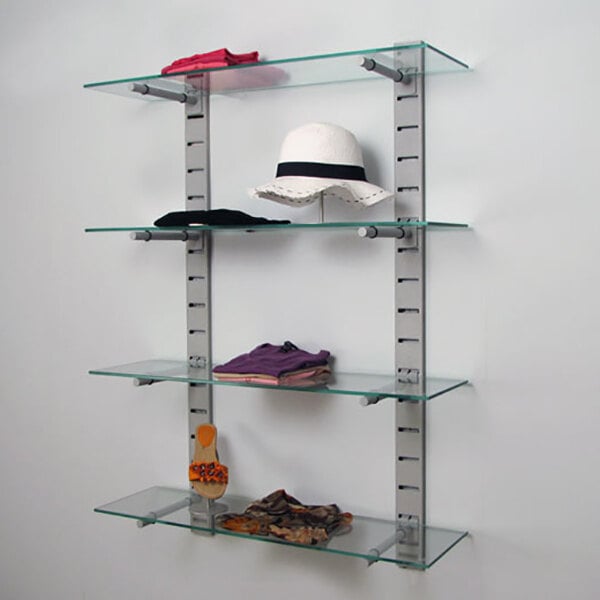A vertical wall-mounted retail display with four glass shelves supported by metal slat strips.