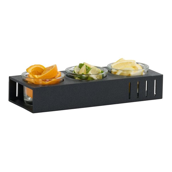A classic 3 jar display featuring three glass jars in a black rectangular holder, each containing different sliced fruits.