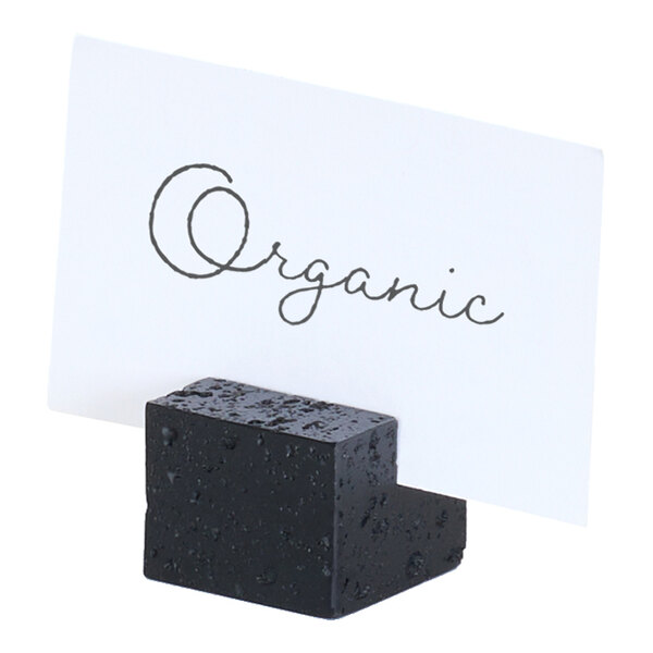 A black resin cube card holder displaying a card labeled 'Organic.'