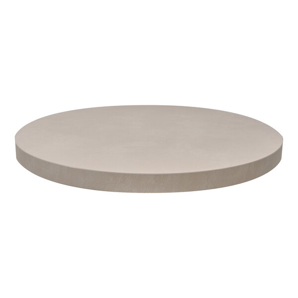 A round, sandstone-colored laminate indoor table top.
