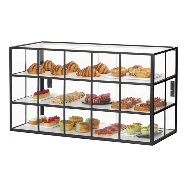 A three-tier black metal bakery display case with glass panels, showcasing assorted pastries and desserts.