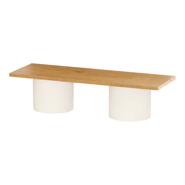 A rectangular rustic pine wood riser shelf with two cylindrical white supports.