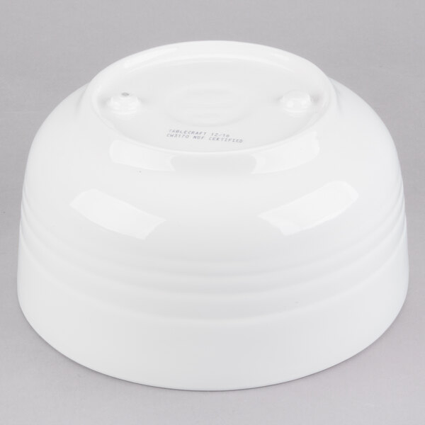 A Tablecraft white cast aluminum fruit bowl on a gray background.