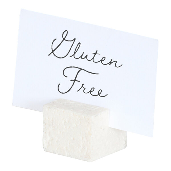 A small ivory resin cube card holder displaying a card labeled 'Gluten Free.'