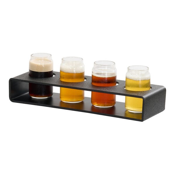 A classic taster caddy holding four small glasses of different types of beer.