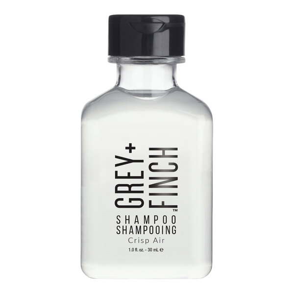 A small clear plastic bottle of Grey + Finch Crisp Air shampoo with a black cap.