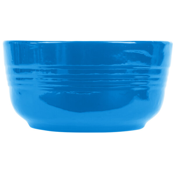 A Tablecraft sky blue cast aluminum bowl with a handle on a white background.