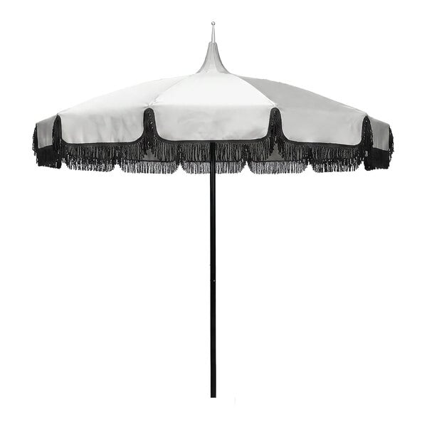 A round outdoor umbrella with a natural-colored canopy, black fringe trim, and a black aluminum pole.