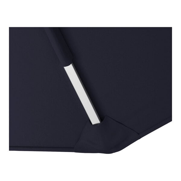 A close-up of a navy blue cantilever umbrella with a silver aluminum support and Sunbrella awning-grade canopy.