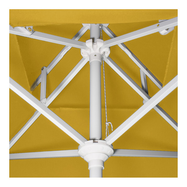 A yellow round patio umbrella with a white aluminum pole and crank lift mechanism.