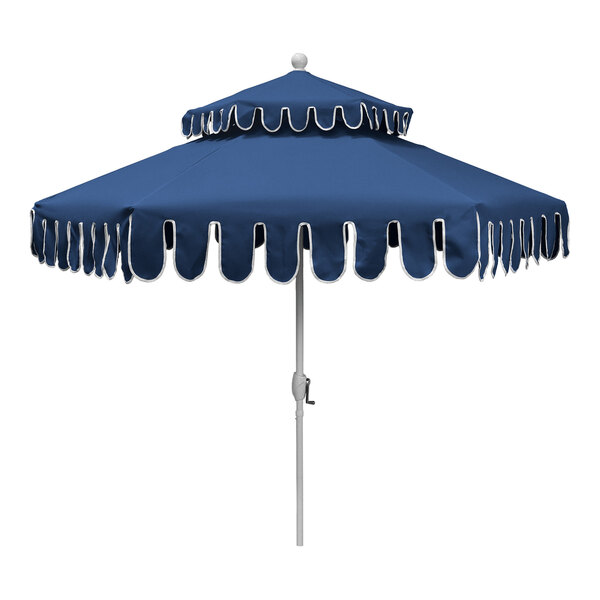 A blue two-tier round patio umbrella with a white aluminum pole and decorative white trim.