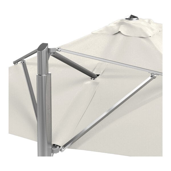 A square cantilever patio umbrella with a natural-colored canopy and a silver aluminum frame.