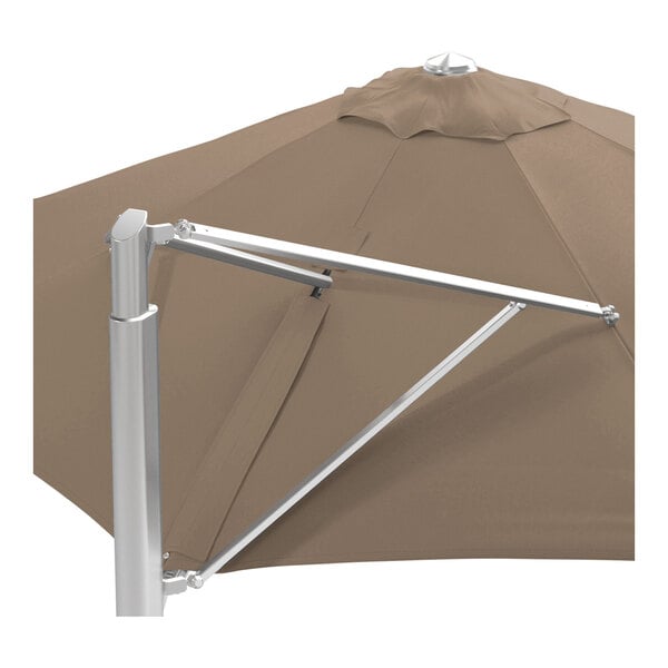 A large taupe round cantilever umbrella with a silver aluminum base and a Sunbrella awning-grade canopy.
