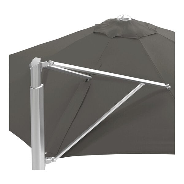 A large charcoal gray round cantilever umbrella with a silver aluminum base and a Sunbrella awning-grade canopy.