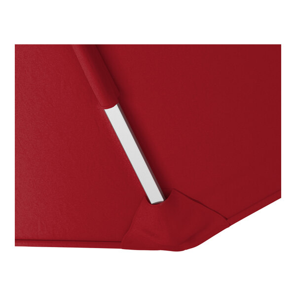 A close-up of a red cantilever umbrella with a silver aluminum support and Sunbrella awning-grade fabric.