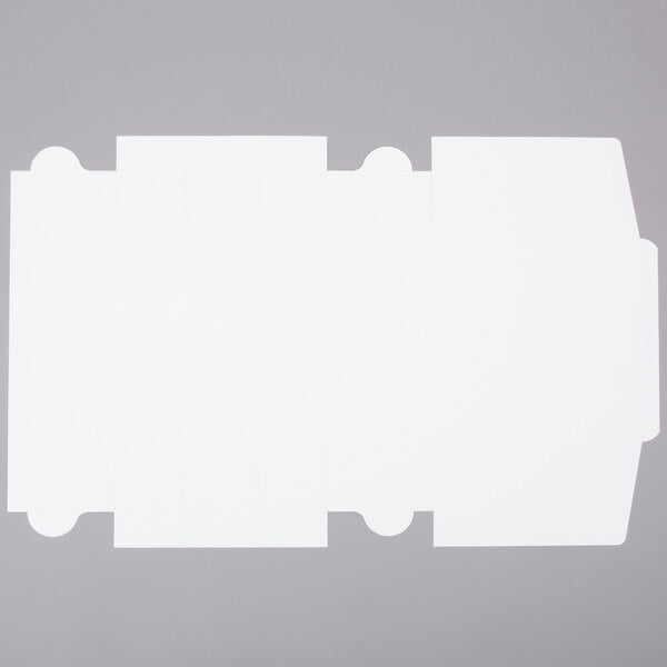 A flat, unfolded white cardboard sheet designed to be assembled into a 12" x 12" x 6" cake or bakery box.