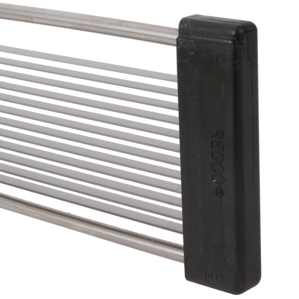 A white metal straight blade assembly for a Vollrath fruit and vegetable cutter.