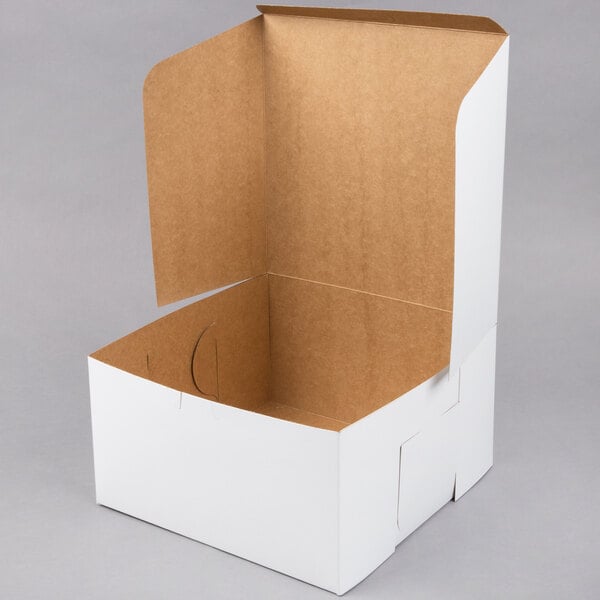 A white cardboard bakery box with an open lid and brown interior.