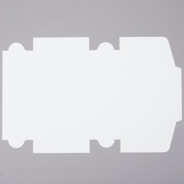 A flat, unfolded white cardboard sheet designed to be assembled into a cake or bakery box.