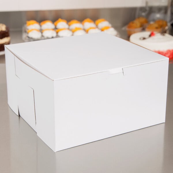 A plain white 10 inch by 10 inch by 5 inch bakery box for cakes or pastries.