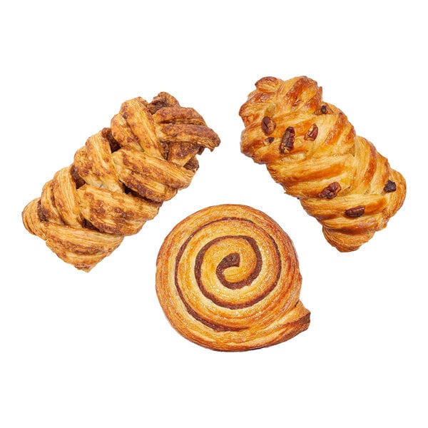 An assortment of three ready-to-bake Danish pastries, including a swirl and two braided varieties, displayed on a white background.