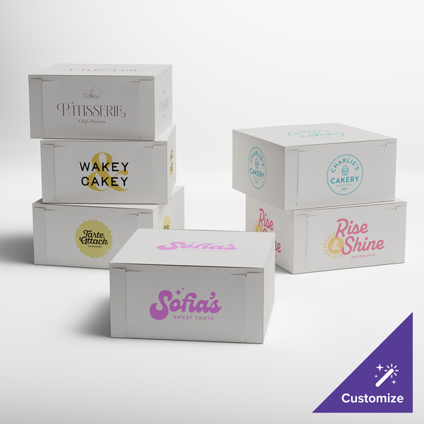 A group of customizable white bakery boxes with various bakery logos printed on them.