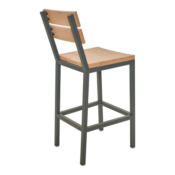 A bar stool with a powder-coated steel frame and natural oak seat and slat back.