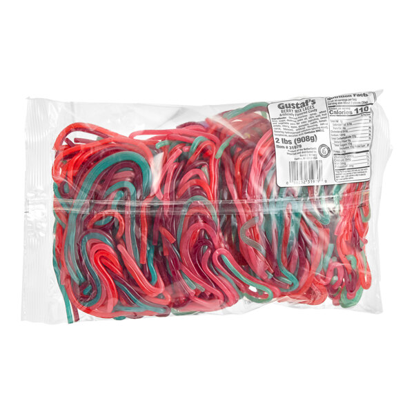 A clear plastic bag containing red and green Gustaf's Very Berry Licorice Laces.