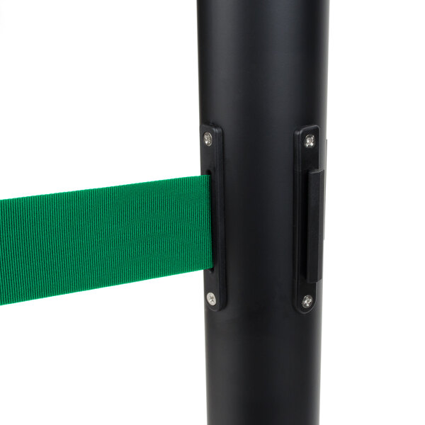 A black Aarco crowd control stanchion with dual green retractable belts.
