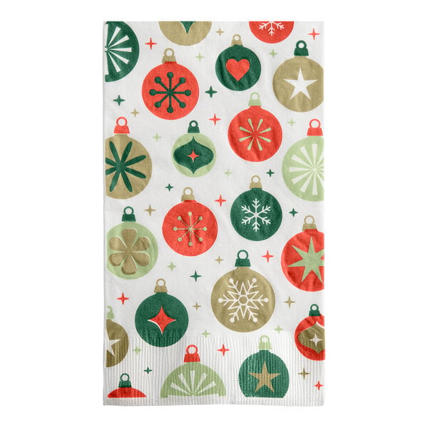 A rectangular white napkin decorated with red, green, and gold Christmas ornament designs.