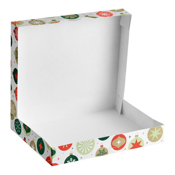 An open, empty white box with colorful ornament designs on the sides and lid.