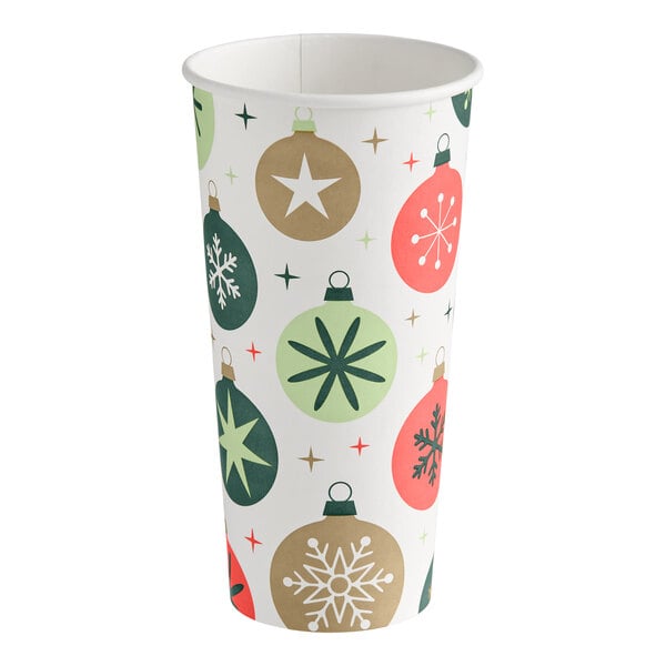 A tall paper cup decorated with colorful Christmas ornament designs in green, gold, and red.