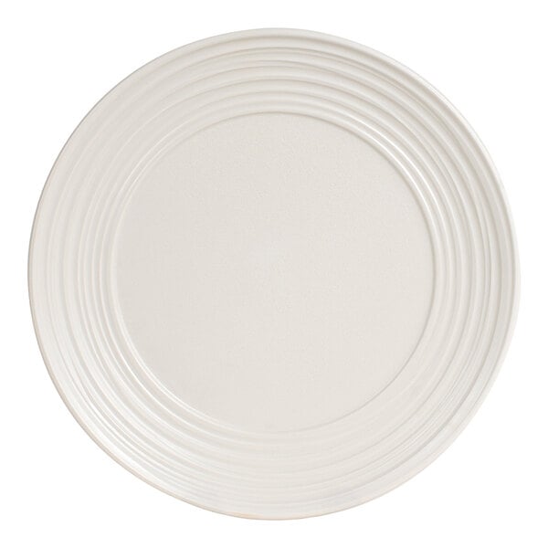 A round, off-white polyethylene plate with a shell-embossed rim design.