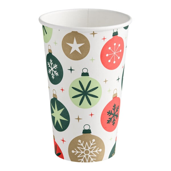 A paper cup decorated with colorful Christmas ornament designs in red, green, and gold.