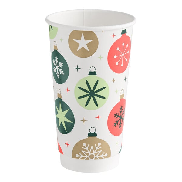 A paper cup decorated with colorful Christmas ornament designs in green, red, and gold tones.