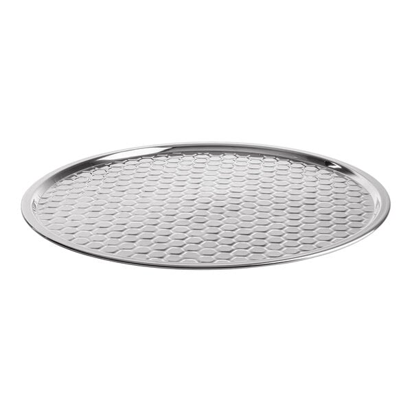 An 18-inch round stainless steel serving tray with a honeycomb pattern from the TableCraft Hive Collection.