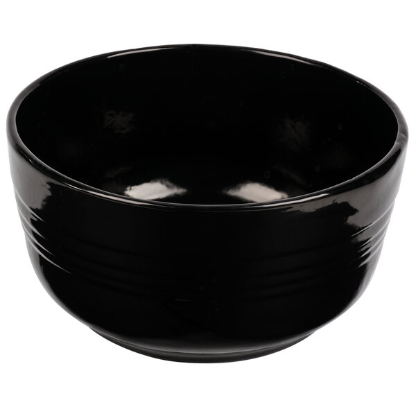 A black Tablecraft cast aluminum fruit bowl with a curved edge.