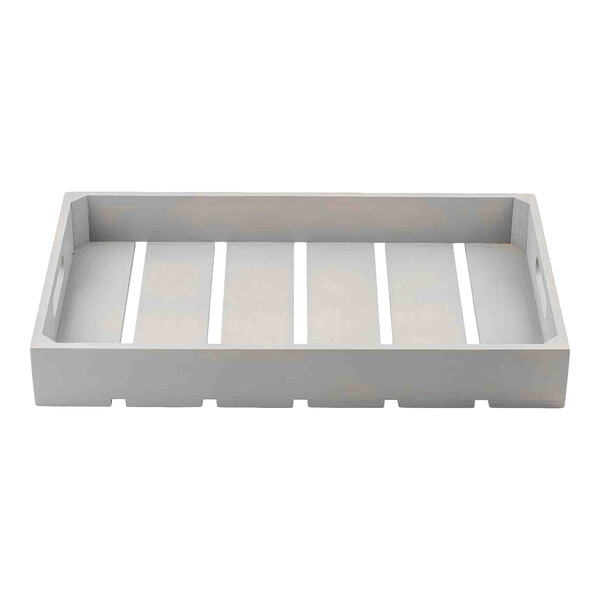 A gray wooden serving and display crate with slatted bottom and cutout handles on the sides.