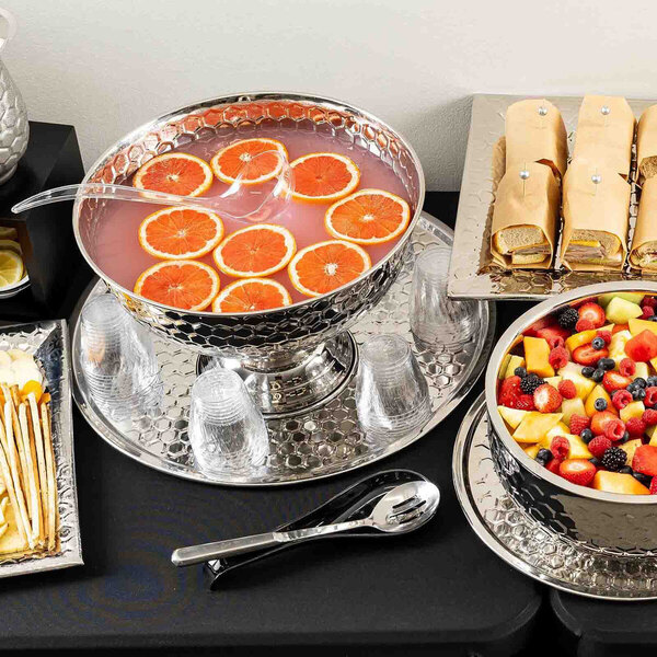A round stainless steel serving tray with a honeycomb pattern, part of the TableCraft Hive Collection.