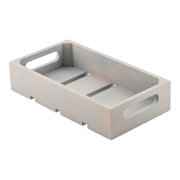 A gray wooden serving and display crate with cutout handles and a slatted base.
