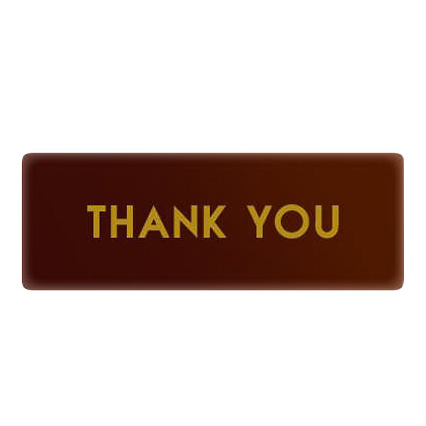 A rectangular chocolate decoration with the words 'THANK YOU' written on it.